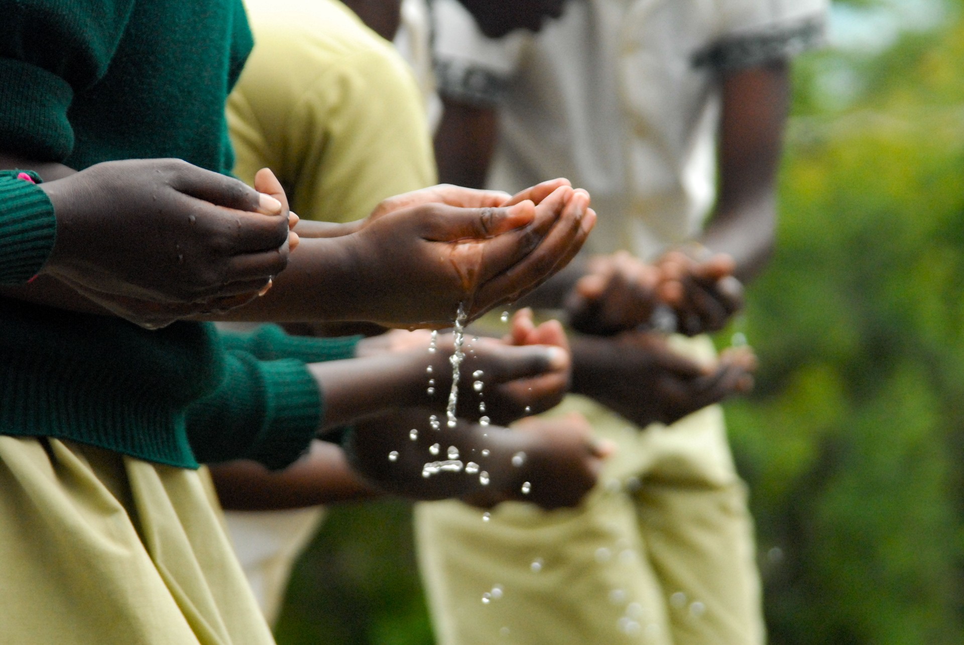 Caring Hands passing on water gamen holding